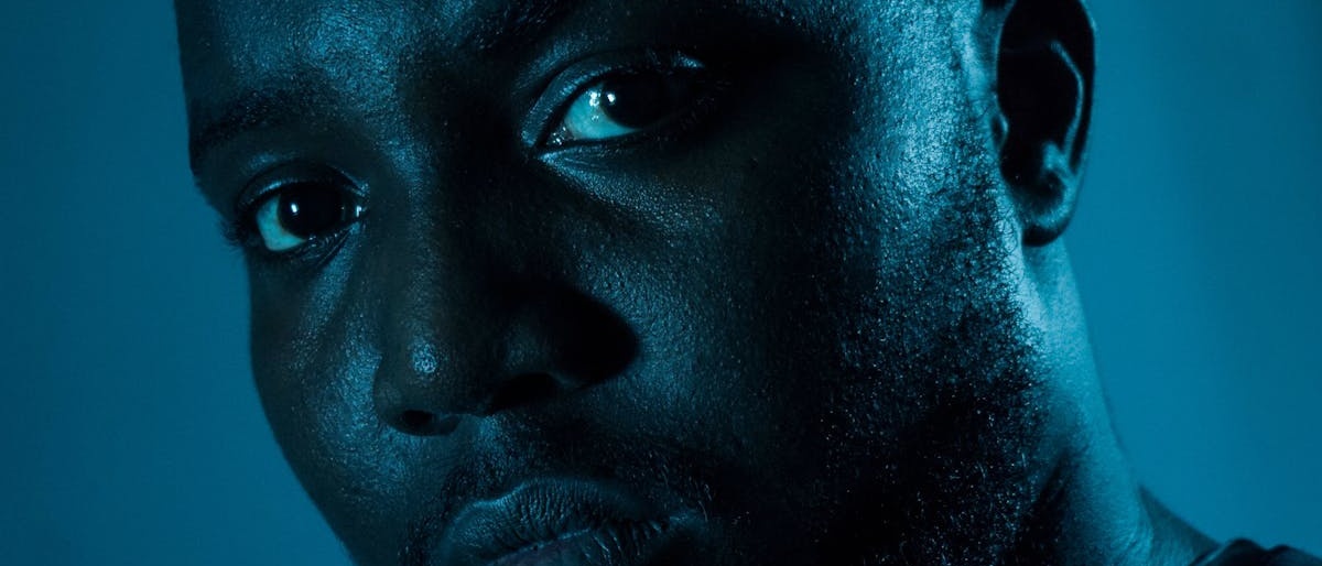 Close-up portrait with cinematic lighting — the human identity at the center of everything