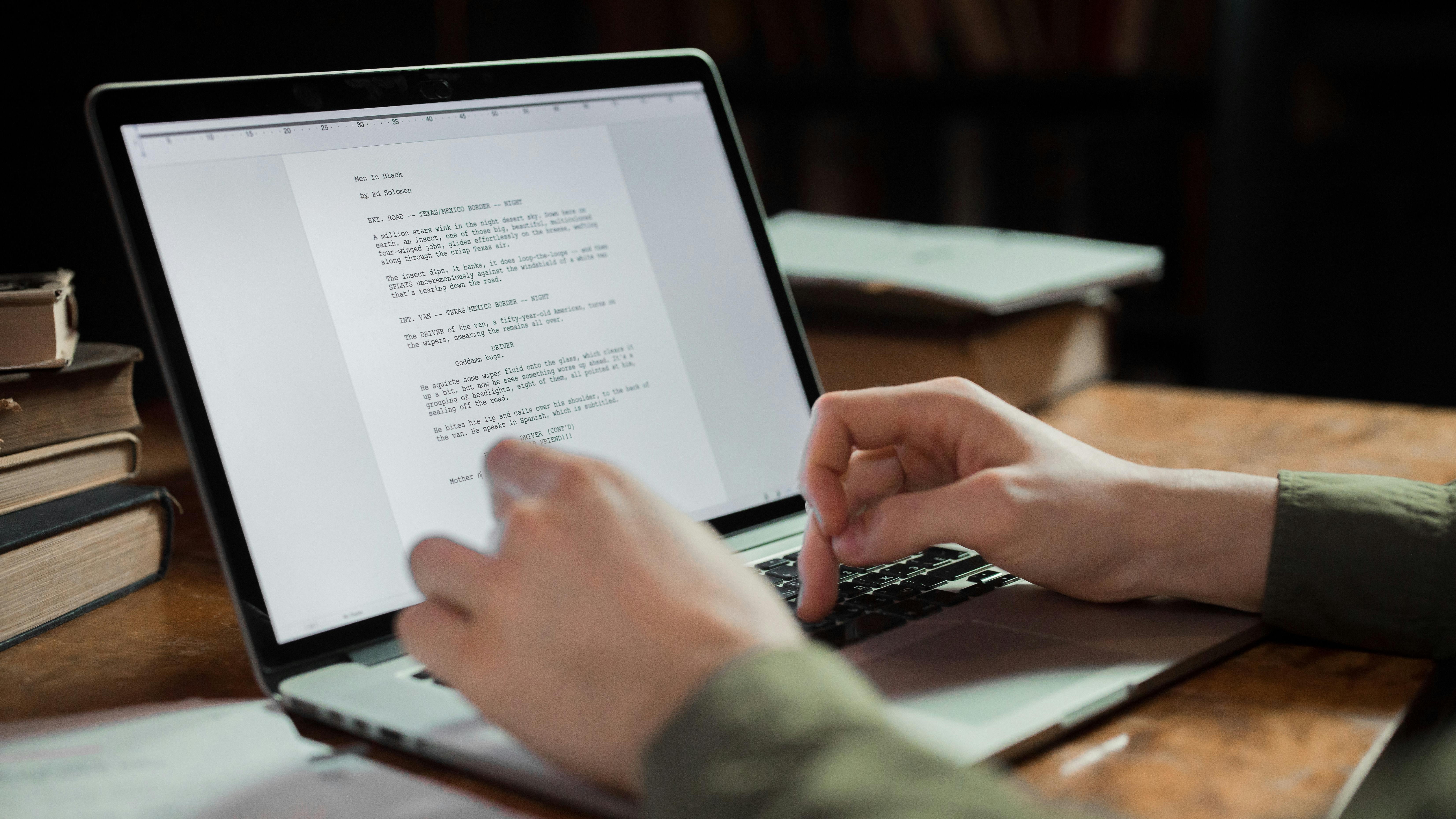 Writer working at a desk with warm lamplight — the creative process that needs protection