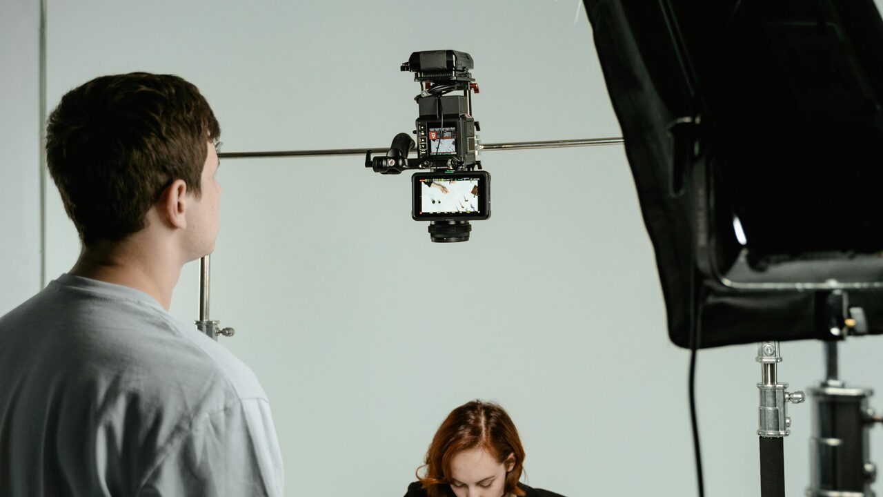 Close-up of a person mid-conversation, warm film grain and teal accent light — behavioral energy captured